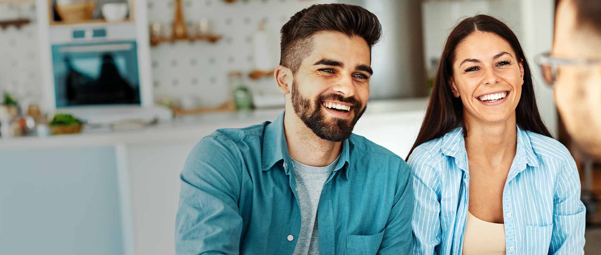 Two people laughing with a third person.