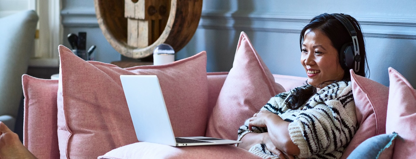 Woman with headphones on laptop