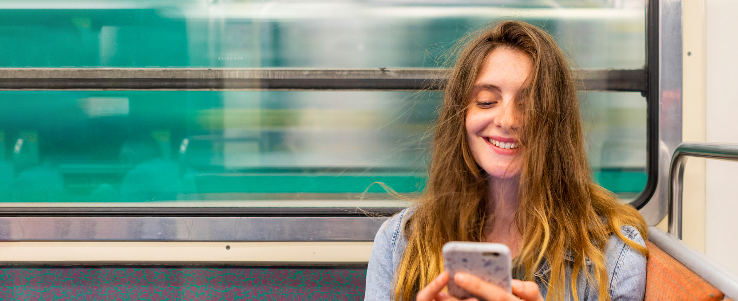 An image of a lady looking at her phone.